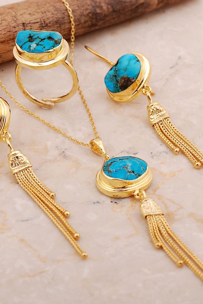 A handmade 925 sterling silver gold plated jewelry set featuring a woven tassel pendant necklace, dangling earrings, and an adjustable ring, all adorned with natural blue turquoise stones.