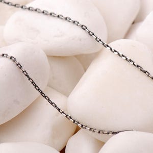 A 50 cm long blackened oxidized silver chain necklace with a sleek 1 mm thickness, displayed on a neutral background.