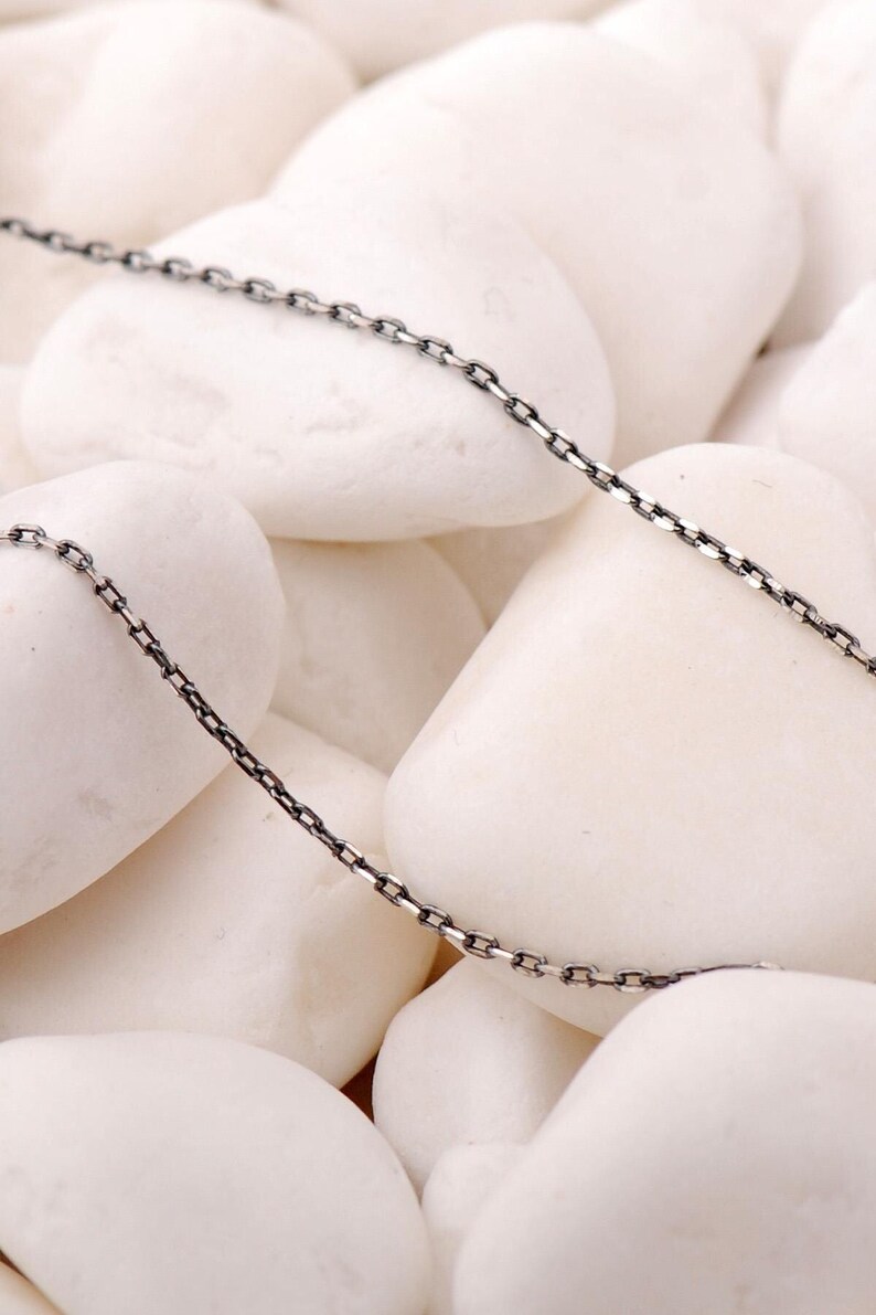 A 50 cm long blackened oxidized silver chain necklace with a sleek 1 mm thickness, displayed on a neutral background.