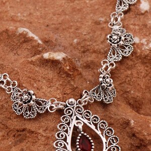 Filigree necklace with red gemstone pendant