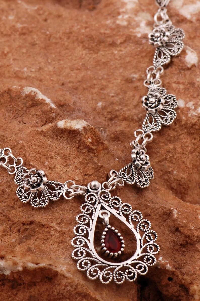 Filigree necklace with red gemstone pendant
