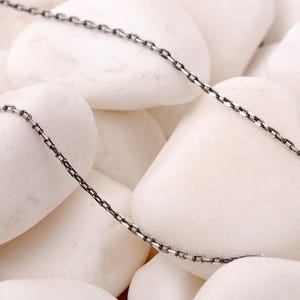 A 45 cm long blackened 925 sterling silver chain necklace with an oxidized finish displayed on a dark background.