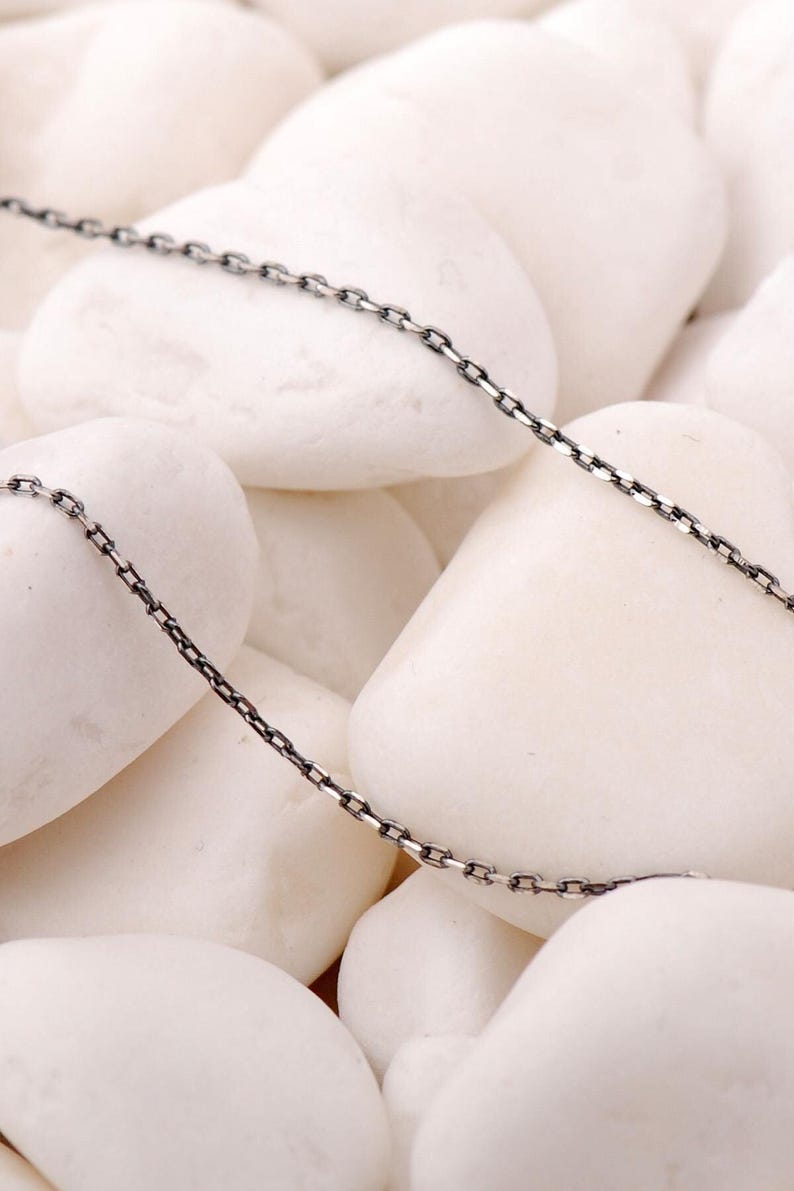 A 45 cm long blackened 925 sterling silver chain necklace with an oxidized finish displayed on a dark background.