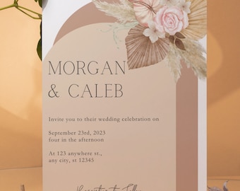 May include: A wedding invitation with a modern design featuring a pink rose and dried pampas grass. The invitation reads "Morgan & Caleb" and includes the wedding date, time, and location. The text "Reception to Follow" is at the bottom of the invitation.