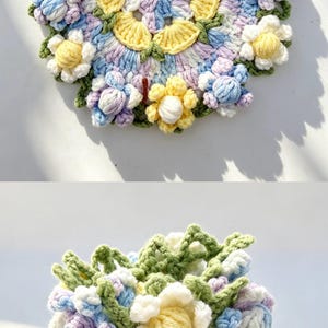 May include: A crochet flower arrangement featuring a brown textured pot filled with white, yellow, blue, and lavender yarn flowers and green leaves, shown from a top-down view and a side view to display the intricate floral pattern and texture.
