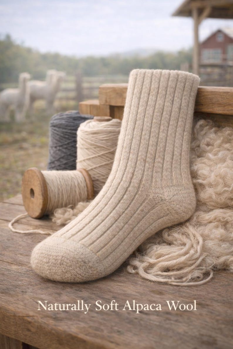 May include: A beige ribbed knit sock made of alpaca wool, positioned next to spools of yarn and loose wool fibers. The text "Naturally Soft Alpaca Wool" is printed at the bottom of the image, which features a rustic wooden surface.