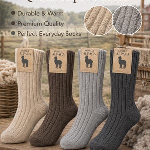 May include: Four ribbed socks in beige, brown, gray, and anthracite colors. Each sock features a tan cardboard tag with the text Qorux Alpaca and an alpaca silhouette. The text Qorux Alpaca Socks appears at the top with bulleted feature points.