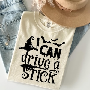 Comfort Colors® I I Can Drive a Stick T-Shirt, Funny Witch Halloween Broomstick Tee, Spooky Season Costume Party Shirt for Witches