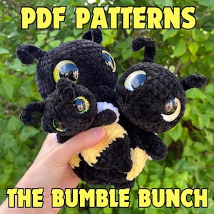 May include: Three crocheted bee plushies in black and yellow. The bees have large, glittery eyes and are holding onto each other. The image text reads "PDF PATTERNS THE BUMBLE BUNCH".