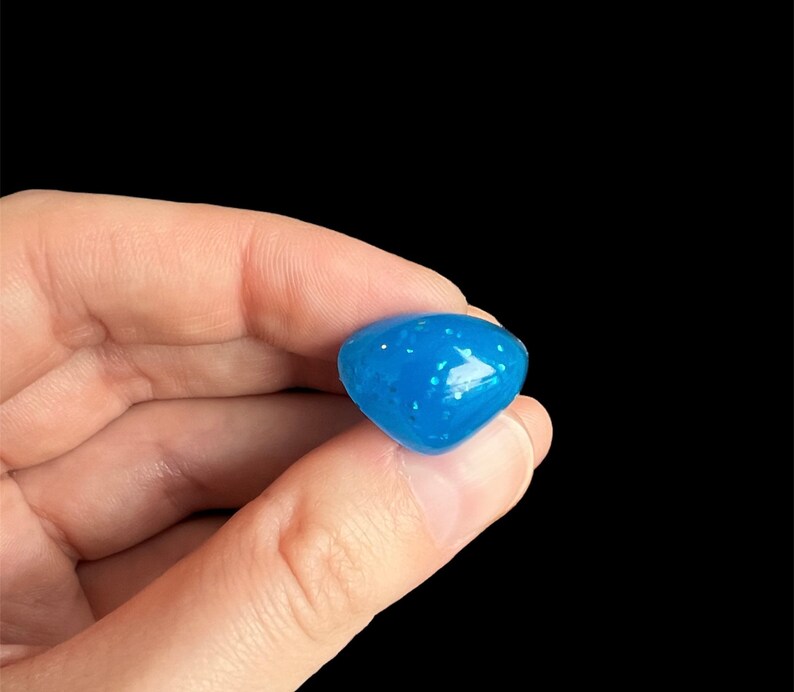 May include: A small, blue, speckled, heart-shaped, silicone mold.