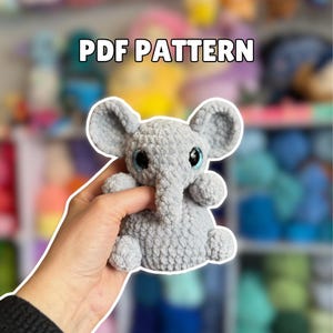 May include: A handmade wooden sign with the text "Welcome" in a playful font. The sign is painted white with a distressed finish, and features a decorative floral design in shades of pink and green. It measures approximately 12 inches wide.