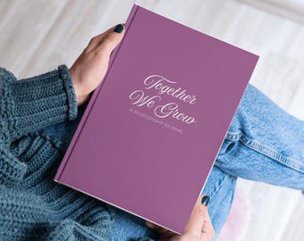 May include: A purple journal with the text "Together We Grow" and the words "A Relationship Journal" printed on the cover.
