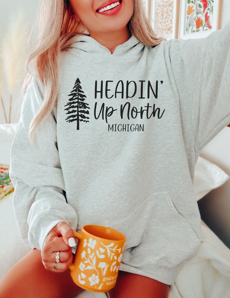 May include: A gray hooded sweatshirt with the text "Headin' Up North Michigan" and a stylized pine tree graphic.