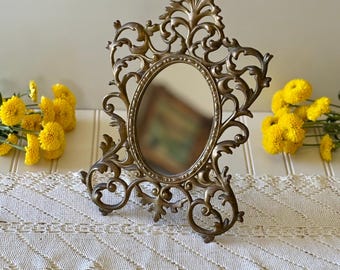 Ornate cast metal frame mirror