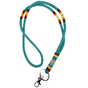 May include: Teal beaded lanyard with a colourful beaded design and a silver swivel clasp.