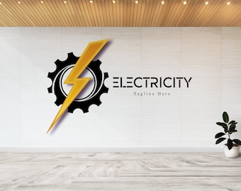 Op de afbeelding: Een zwart en geel logo met een bliksem in een tandwiel. De tekst "ELECTRICITY" is in zwart met de tagline "Tagline Here" eronder.