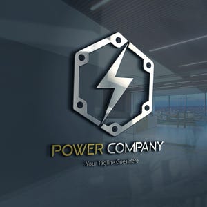 May include: A silver hexagonal logo with a lightning bolt inside. The text "POWER COMPANY" is in gold below the logo, with the tagline "Your Tagline Goes Here" underneath.