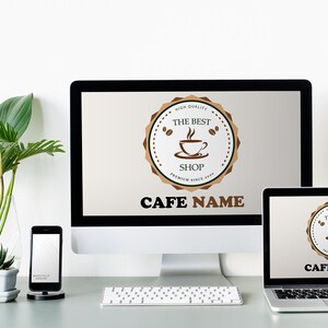 May include: A white desktop computer, a laptop computer, and a smartphone are on a gray table. The desktop computer and laptop have the same logo on their screens, which says "The Best Shop" with a coffee cup icon. The text "Cafe Name" is below the logo. A green plant is in a clear vase on the table.