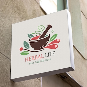 May include: A white sign with a brown mortar and pestle, green leaves, and red cinnamon sticks. The text "HERBAL LIFE" is in black with the tagline "Your Tagline Here" below.