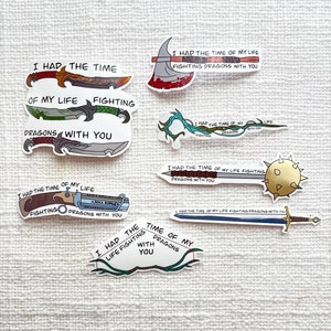 May include: A set of nine stickers featuring various weapons and the text "I had the time of my life fighting dragons with you". The stickers are printed on white paper with colorful illustrations.