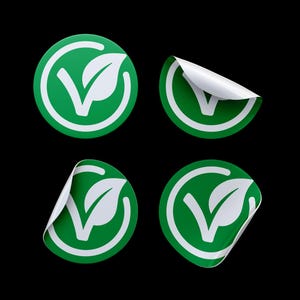 May include: Four green and white round stickers with a leaf and checkmark design. The stickers are partially peeled back to show the white adhesive backing.