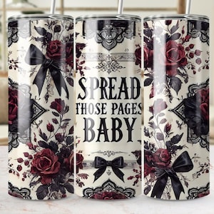 May include: A white tumbler with a black and red floral design and the text "Spread those pages baby".