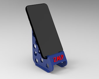 May include: A blue phone stand with a honeycomb pattern and the word "ZALP" printed on the front. A black smartphone is placed in the stand.