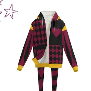 May include: A burgundy and black hoodie and matching leggings set. The hoodie features a heart and diamond pattern, with yellow trim and a white interior. The leggings have a striped pattern. The set is designed with a unique, whimsical style.