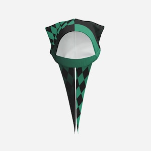 May include: A headscarf featuring a black and teal green diamond pattern. The fabric is split into two distinct sections, with a solid teal green band framing the face opening. Two long, pointed fabric tails extend downward from the base.
