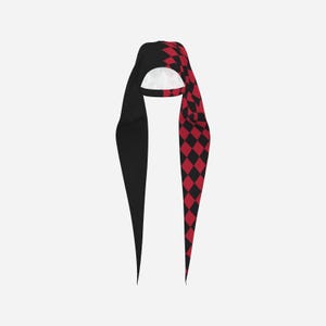 May include: A long, pointed hood featuring a split design with one side in solid black and the other side in a red and black diamond harlequin pattern. The interior lining of the hood is white, and the garment has two long, tapered fabric tails.