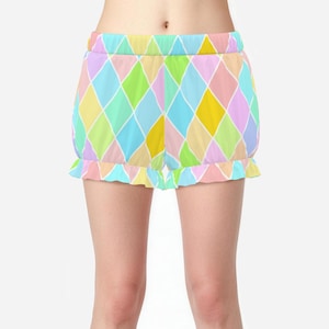 May include: High-waisted shorts featuring a colorful harlequin diamond pattern in shades of pastel yellow, light blue, lime green, lavender, and soft pink, separated by thin white lines, finished with a ruffled hem and an elasticized waistband.