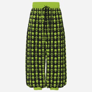 May include: Black sweatpants featuring a repeating lime green pattern of alien heads, flying saucers, and stars. The garment has a lime green elastic waistband with a black drawstring and matching lime green elastic cuffs at the ankles.