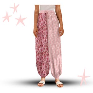 May include: Pink harem pants with a split design. One side features a rose print, while the other has a diamond pattern. The pants have a drawstring waist and are worn with white sandals. The overall style is casual and feminine.