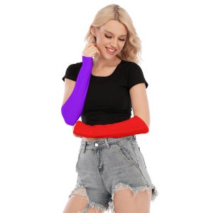 May include: A woman wearing a black t-shirt and denim shorts, with one arm covered in a purple sleeve and the other in a red sleeve. The sleeves appear to be made of a stretchy material.