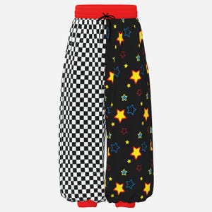 Puede incluir: Pantalones de chándal con diseño dividido, con un patrón de cuadros blancos y negros en una pierna y un fondo negro con estrellas amarillas y azules en la otra. Los pantalones tienen una cintura elástica roja brillante y puños rojos.