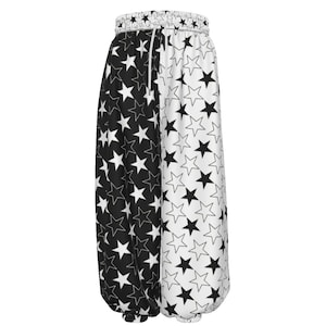 May include: Harem trousers with a black and white star pattern. The design is split vertically, with one side displaying black stars on white and the other white stars on black. The waistband is elasticated with a drawstring for adjustment.