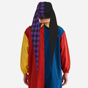 May include: A jester costume featuring a long-sleeved jumpsuit with a color-blocked design in red, blue, and yellow. The matching hat has two long, pointed tails, one solid black and one with a purple and black diamond pattern, and a ruffled collar.