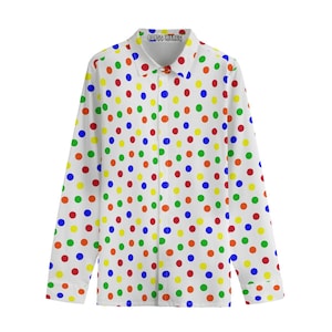 May include: White shirt with a polka dot design in red, yellow, green, and blue. The long-sleeved shirt has a collar and button closure. The text "ABYSS WARES" is printed on the collar.