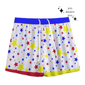 May include: White swim shorts patterned with red, yellow, and blue stars. The waistband is blue, and the bottom edges are red and yellow. The shorts have a white drawstring.