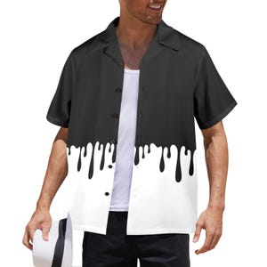 May include: A short-sleeved button-down shirt with a unique design. The top half is solid black, transitioning to a white bottom half with black dripping paint effect. The shirt is worn over a white undershirt.
