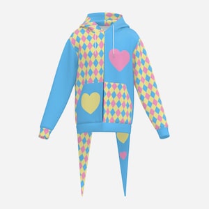 May include: A zip-up hoodie featuring a light blue base with a repeating diamond pattern in pink and yellow. The garment includes a large pink heart on the left chest and a yellow heart on the right pocket area, with long pointed fabric tails at the hem.