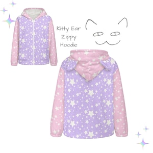 Puede incluir: Una sudadera con capucha con cremallera Kitty Ear de color lavanda y rosa con un estampado de estrellas blancas. La sudadera tiene una cremallera frontal, bolsillos y detalles de orejas de gato en la capucha.