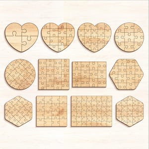 May include: A collection of wooden jigsaw puzzles in various shapes, including hearts, circles, squares, and hexagons. Each puzzle is made of light-colored wood and features the classic interlocking piece design.