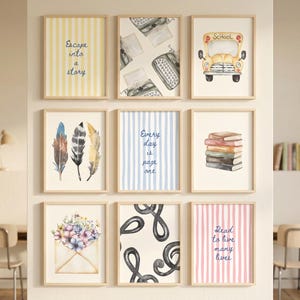 May include: A gallery wall of nine framed prints featuring watercolor illustrations. Designs include a yellow striped print with text Escape into a story, vintage typewriters, a yellow school bus, feathers, blue stripes with text Every day is page one, a stack of books, a floral envelope, black swirls, and pink stripes with text Read to live many lives.