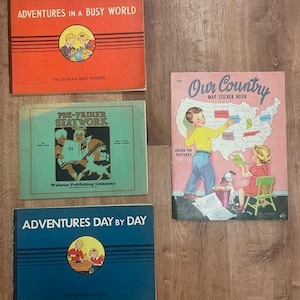 May include: Four vintage children's books with colourful covers. The books are titled "Adventures in a Busy World", "Our Country Map Sticker Book", "Pre-Primer Seatwork", and "Adventures Day by Day".