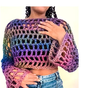 May include: A rainbow crochet top with a loose, open-weave design and bell sleeves. The top is cropped and has a relaxed fit.
