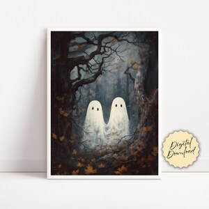 May include: A framed print depicting two white ghosts in a dark forest setting. The artwork has an autumnal theme, with brown and orange leaves. The text "Digital Download" is on a yellow sticker. The overall mood is spooky.