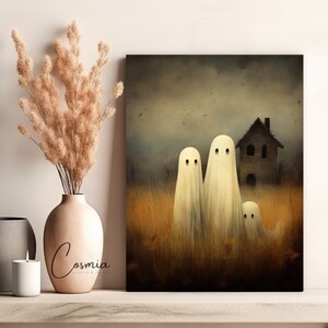 May include: A canvas print featuring a spooky Halloween scene. Three white ghost figures stand in a field of tall grass, with a haunted house in the background. The artwork has a vintage, painterly style.