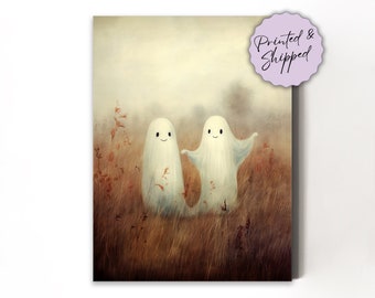 May include: Two white ghosts with smiling faces stand in a field of tall brown grass. The ghosts are holding hands and appear to be dancing.