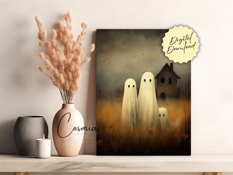 May include: A digital download print featuring a spooky Halloween scene. Three white ghost figures stand in a field of tall grass, with a house in the background. The print has a vintage, painterly style, with the words "Digital Download" on a yellow tag.